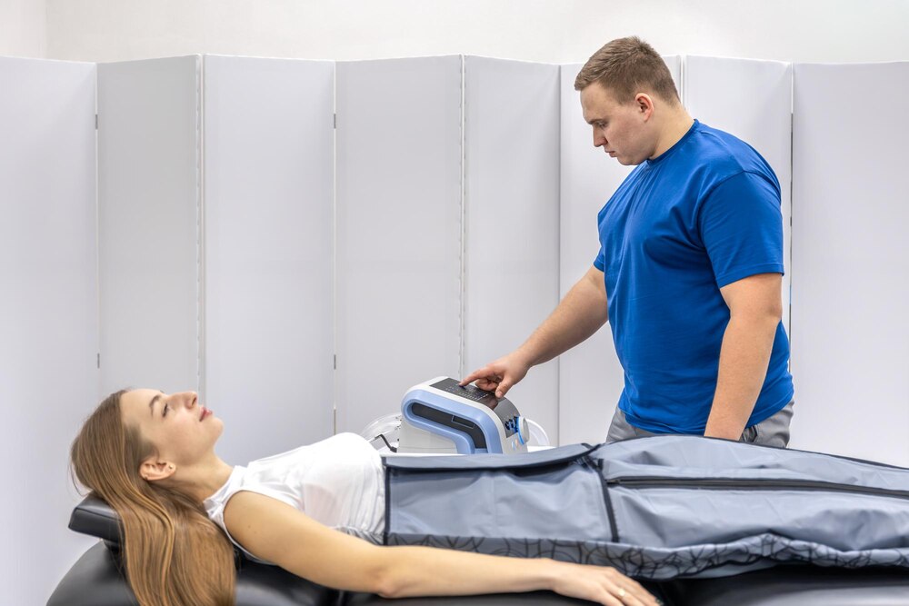 Doctor monitors pressotherapy device with woman patient rehabilitation care