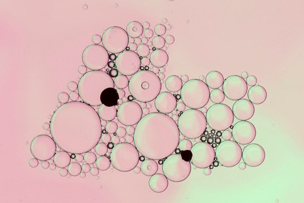 Pale pink abstract bubbles with black dots